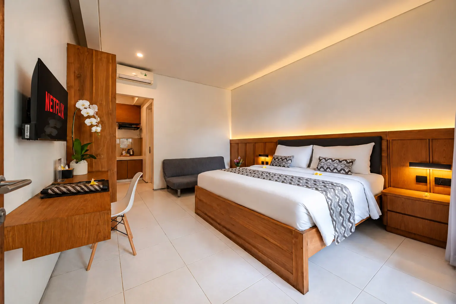 Premier Suite at Bali True Living in Denpasar, Bali, with teak furnishings and a king-size bed